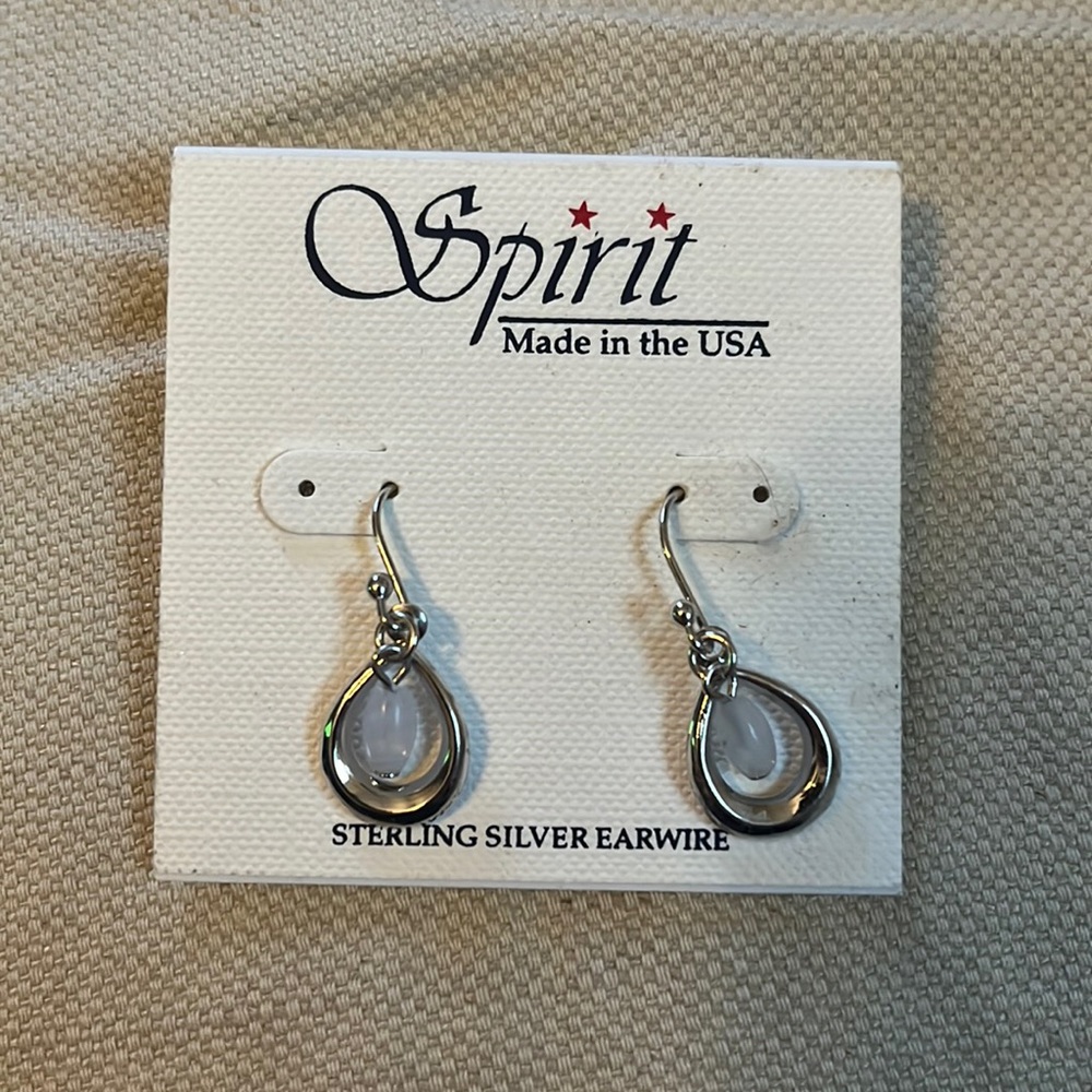 Stirling silver, rhodium finish. Made in the USA- new, great condition